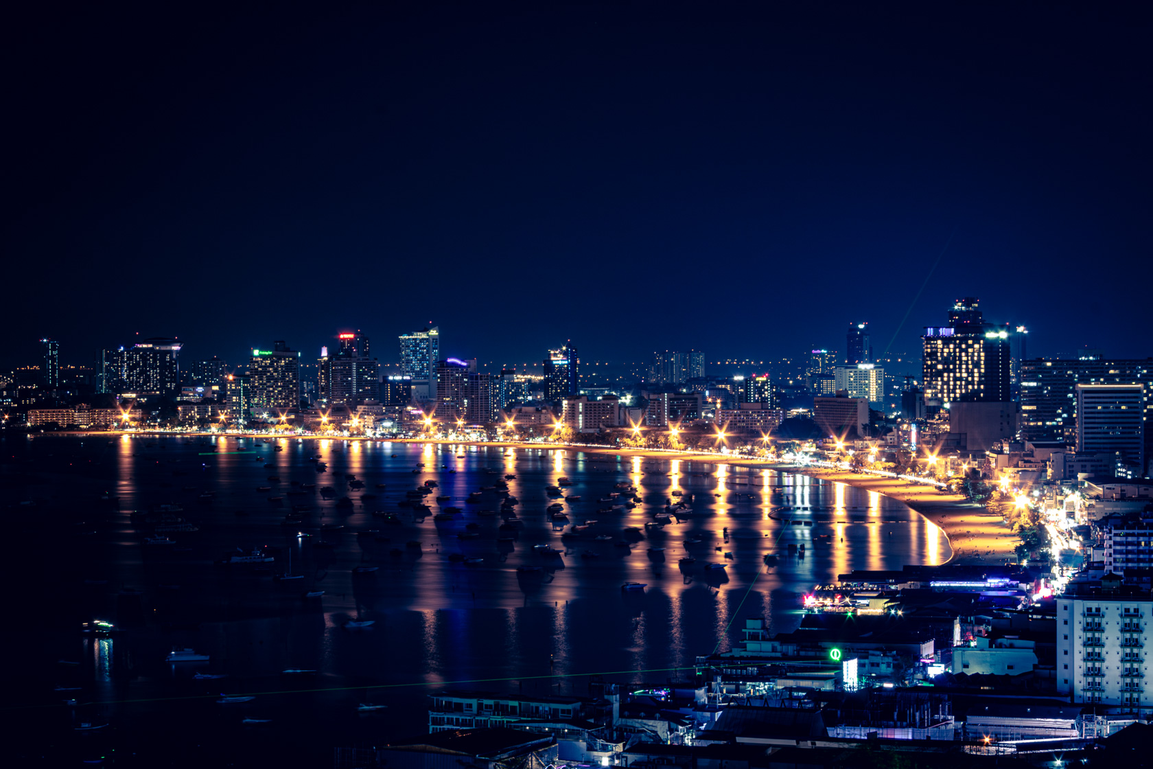 Aerial night view of Pattaya Beach Road illuminated by city lights in Pattaya, Thailand.