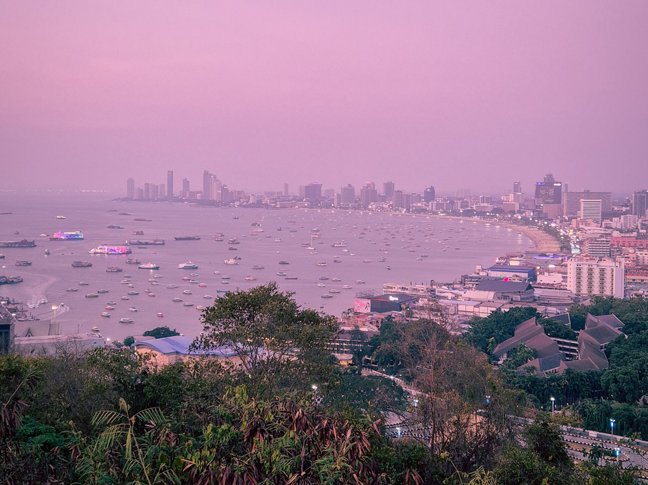 Panoramic sunset view of Pattaya Beach Road and the coastline from a viewpoint in Pattaya, Thailand.