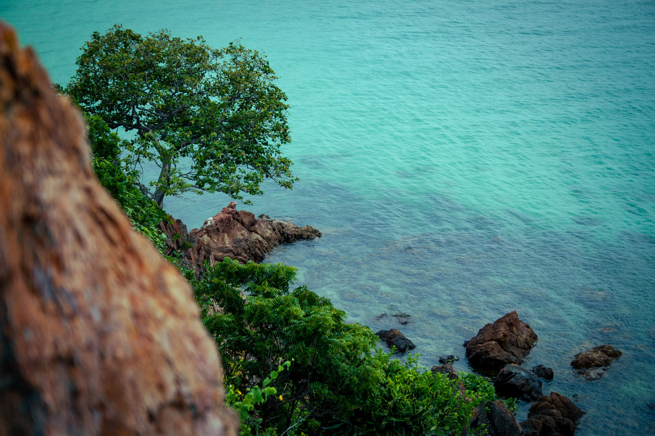 Rocky coastline and turquoise sea viewed from Ko Lan near Pattaya, Thailand